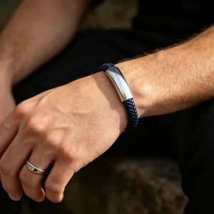 Blue braided leather bracelet detail shot showing the sleek curved steel magnetic clasp.