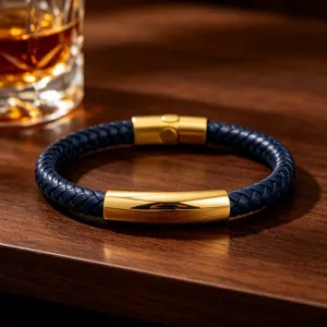 Detail shot of men's royal blue braided leather bracelet with gold stainless steel clasp.