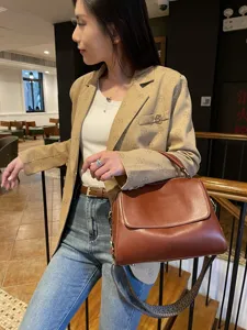 Retro brown genuine leather Boston bag, elegant women's handbag for daily commute and casual use.