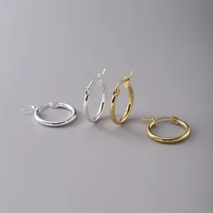 Close-up of minimalist polished gold and silver 316L stainless steel hoop earrings set