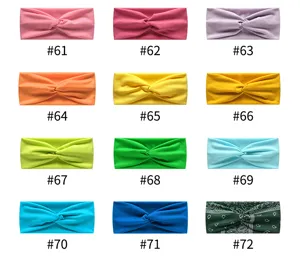Detailed view of elastic knotted yoga headbands in multiple vibrant solid colors and patterns.