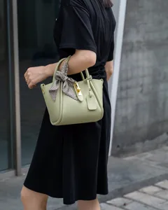 Chic leather bucket bag for women, versatile shoulder crossbody with stylish metal lock.