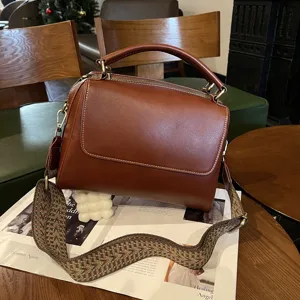 Retro brown soft leather Boston bag with wide woven strap, chic daily cross-body shoulder handbag.