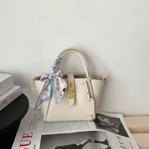 Elegant beige genuine leather bucket bag with stylish printed silk scarf, minimalist daily handbag.