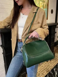 Vintage dark green genuine leather Boston handbag with top handle and crossbody strap for women.