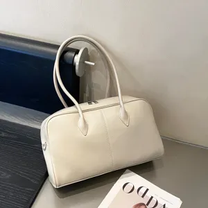Detail view of beige genuine leather tote bag, natural tumbled cowhide shoulder handbag.