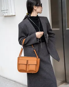 Stylish brown leather shoulder bag with dual front pockets, premium large capacity tote design.