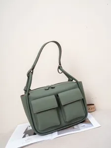 Detailed view of the green genuine leather shoulder bag with multi pockets and zip closure.