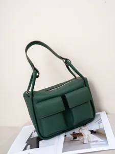 Green leather shoulder bag detail, premium cowhide material with spacious multi-pocket design.