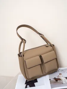 Genuine leather shoulder bag for women, large capacity tote with stylish front pockets.
