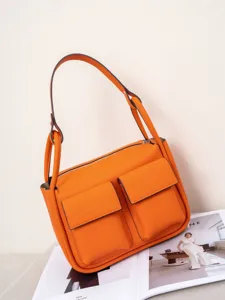 Orange Togo cowhide shoulder bag, large capacity versatile crossbody tote for women.