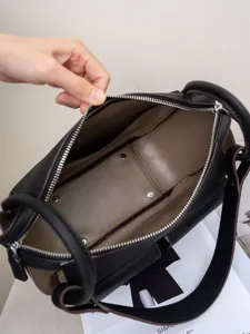 Black genuine leather shoulder crossbody bag with unique geometric panel design and spacious interior.
