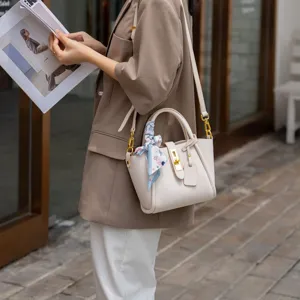 Elegant genuine leather bucket bag for women, versatile crossbody shoulder bag with lock.