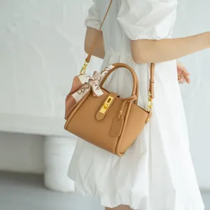 Stylish genuine leather bucket bag with top handle, chic lock and scarf decoration.