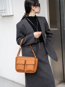 Genuine leather tote bag with dual front pockets, stylish brown shoulder crossbody bag for women.