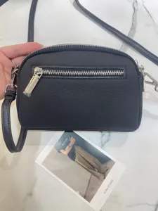 Genuine leather crossbody bag detail, black small square shoulder bag with metal zipper.