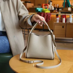Classic genuine leather bucket bag for women, versatile shoulder handbag for daily commuter use.