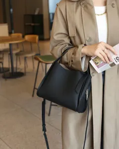 Black genuine leather bucket bag for women, large capacity stylish shoulder handbag.