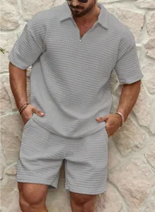 Detailed view of men's casual waffle knit polo shirt and shorts set in solid grey.