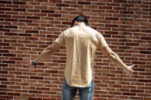 Back view detail of casual men's short sleeve t-shirt showcasing curved hem and soft fabric.