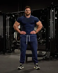 Men's dark blue athletic gym t-shirt and matching training sweatpants for workout session detail view