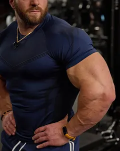 Men's fitness t-shirt detail showing tight athletic fit and high elasticity fabric texture.