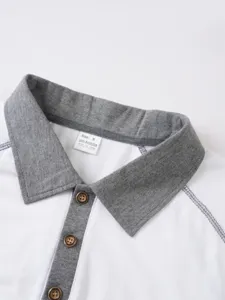 Men polo shirt collar detail, white fabric with grey contrast design and button placket.