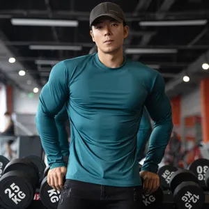 Detail view of men long sleeve athletic gym t shirt in dark green fitted slim solid color.