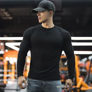 Detailed view of men's slim fit solid color long sleeve Henley t-shirt for sports fitness.