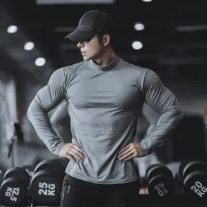 Men's grey athletic long sleeve shirt detail, mock neck quick dry fitness workout compression top.