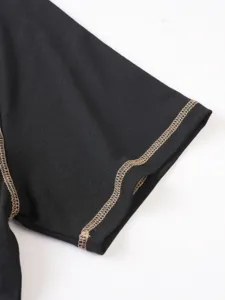 Close-up detail shot of men's black short sleeve t-shirt cuff with contrast stitching.
