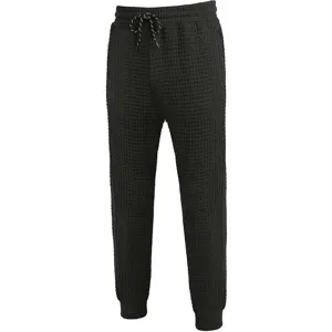 Men black waffle knit casual pants featuring a comfortable drawstring waist and stylish tapered cuffs.