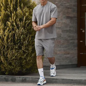 Close-up detail view of men casual sportswear set, solid grey crew neck t-shirt and shorts.