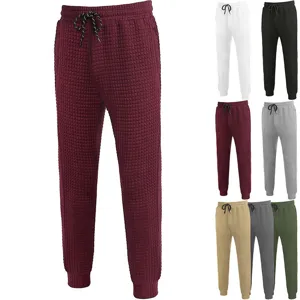 Waffle knit casual trousers fabric texture detail, drawstring waist and elastic cuffs design.
