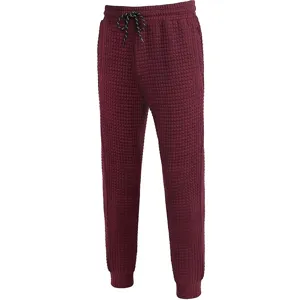 Close-up view of mens dark red waffle knit sweatpants with adjustable drawstring waistband.