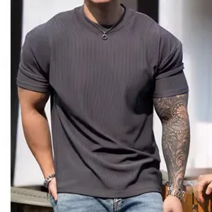 Dark grey ribbed men's short sleeve t-shirt detail showcasing texture and shoulder fit.