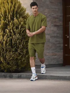 Men casual sportswear set olive green short sleeve t-shirt and matching shorts stylish activewear.