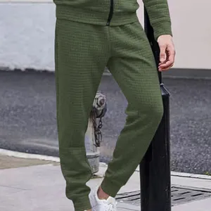 Detail view of men's army green waffle knit casual pants, showing texture and close-up fit.