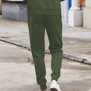 Men's dark green waffle knit casual joggers, comfortable loose fit pants with cuffed hems.