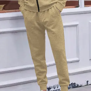 Detail view of men casual waffle texture joggers trousers in khaki loose fit comfortable wear.