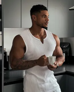 Close-up view of men's ribbed knit V-neck tank top in white, lifestyle kitchen scene detail.