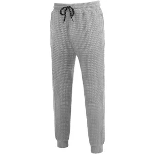 Men's casual waffle knit sweatpants with drawstring and tapered cuffs for autumn wear.