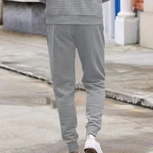 Mens grey waffle knit casual pants detail view showcasing textured fabric design.