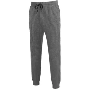 Detailed view of grey waffle knit casual pants, elastic drawstring waist and cuffed hem.
