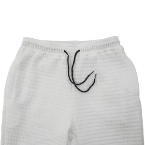 Mens casual pants detail shot showing the textured grid fabric and adjustable drawstring.