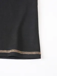 Detailed close-up of men casual t-shirt hem with contrast stitching design in classic black.