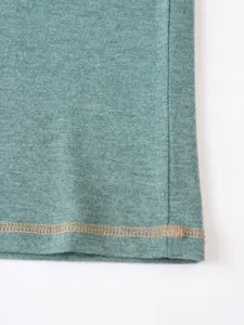Men's casual polo shirt fabric and hem detail close-up, premium breathable knitwear.