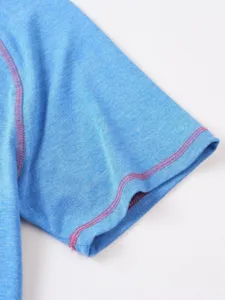 Close-up detail of blue short sleeve shirt with pink contrast stitching and soft fabric.