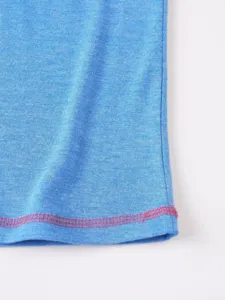 Close up detail of mens blue knit fabric apparel with contrast pink stitching hem design.