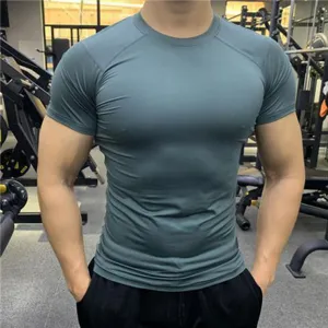 Close-up detail of men's slim fit quick-dry gym training short-sleeve athletic t-shirt in green.